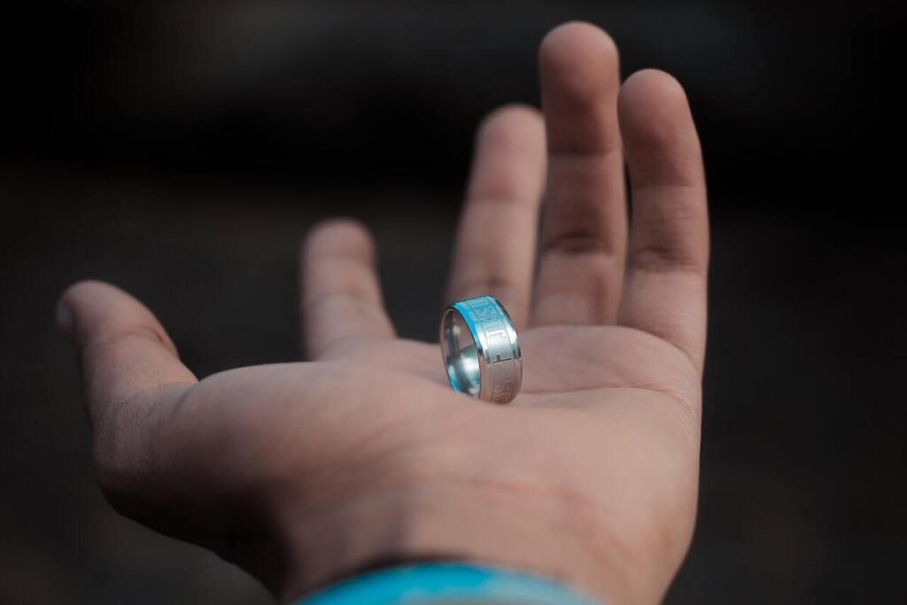 a man's wedding ring on the palm of a hand