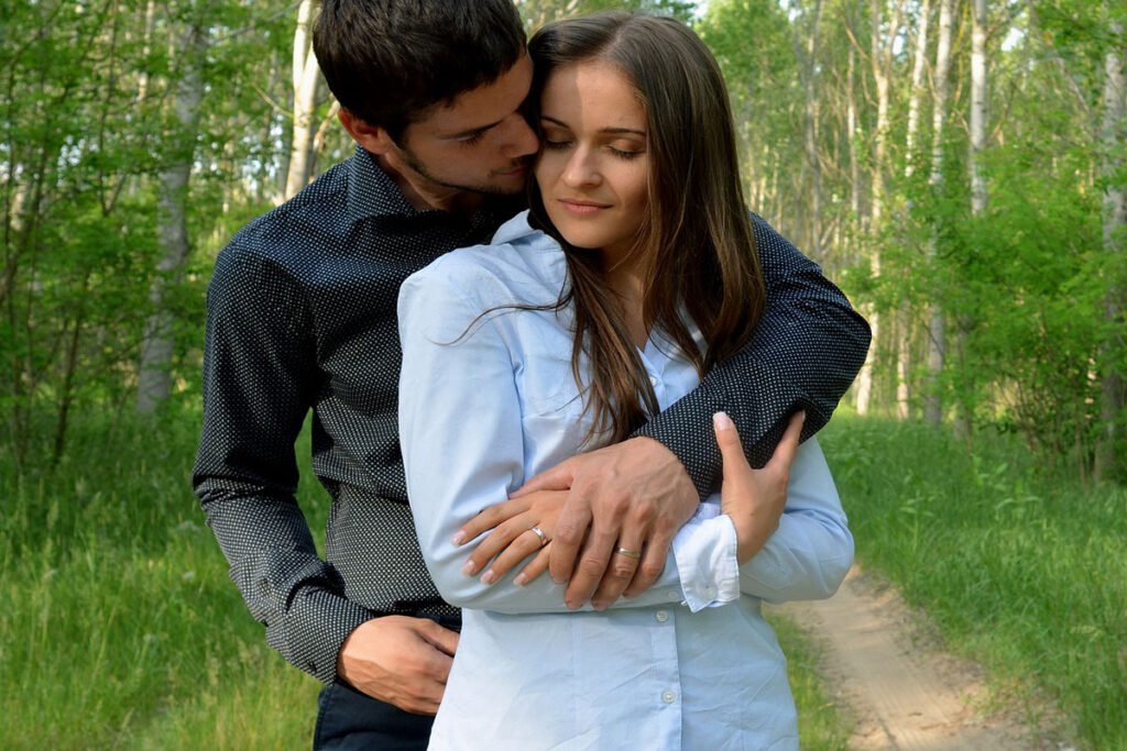 man hugging woman from behind