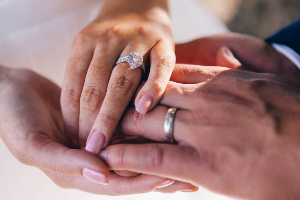 Engagement rings on a couple's fingers