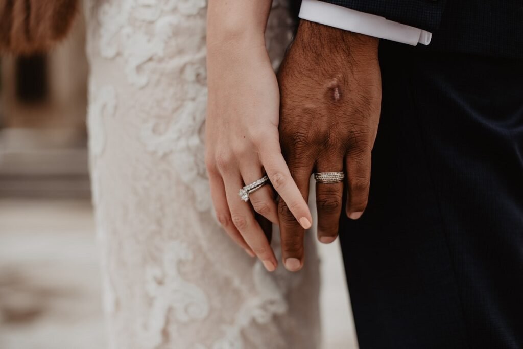 Engagement rings on a couple's fingers
